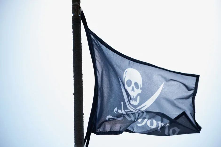 A pirate ship at sea with a digital simulation overlay evoking Assassin’s Creed: Black Flag.