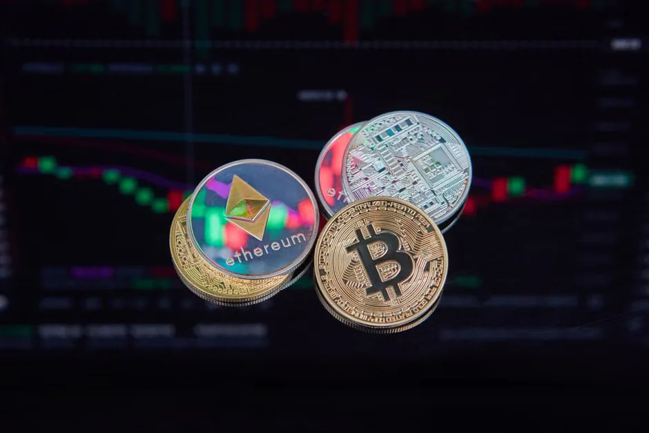 A person looking at a computer screen with a graph of cryptocurrency prices in the background.