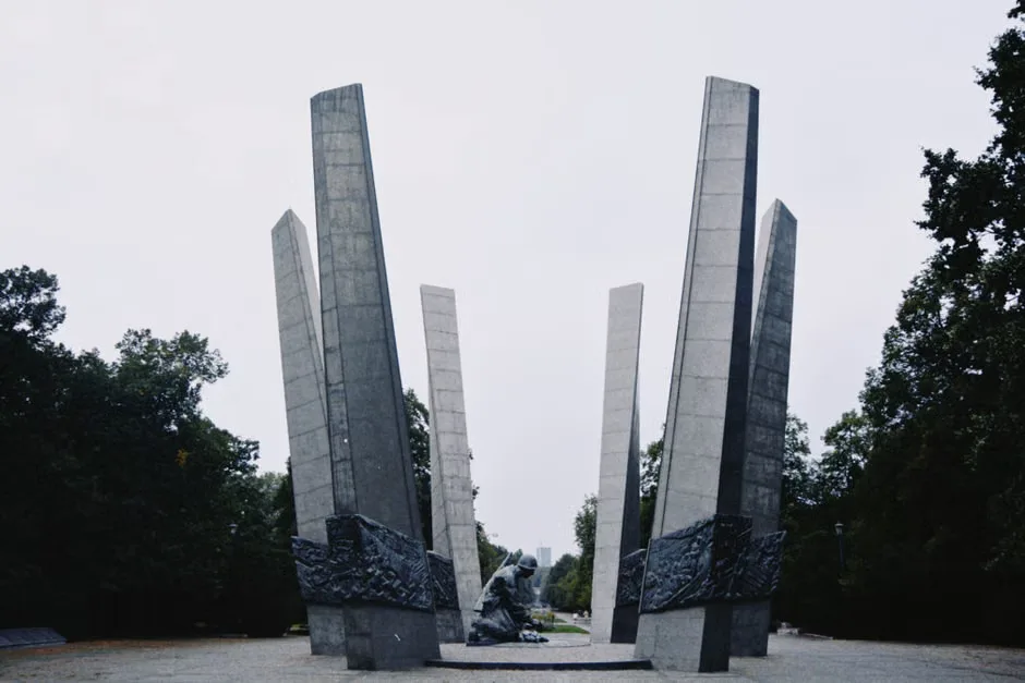 Candles and flowers placed at a memorial site in Poland for World War II victims