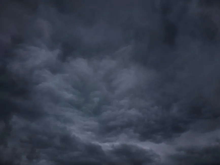 Dark clouds and rain moving across an Arkansas city during a wet weather forecast